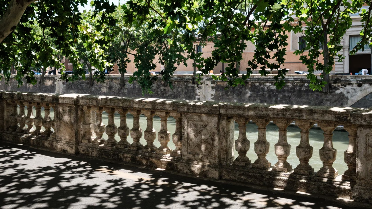Sunlit Leaf Shadows on Stone Rail Along Rome's Tiber Riverbank in Bright Midmorning Light in in Rome, Italy