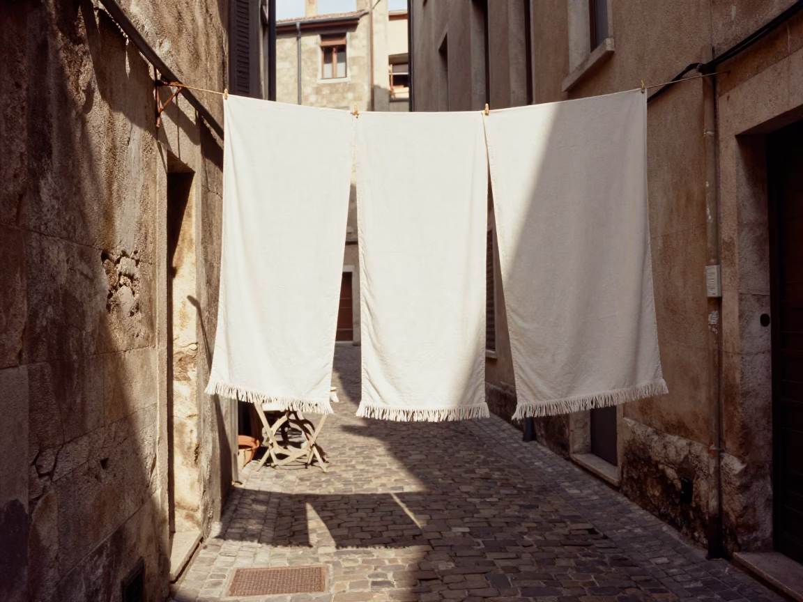 Sunlit Lyon Alleyway with Hanging Linen and Outdoor Dining Setup in in Lyon, France