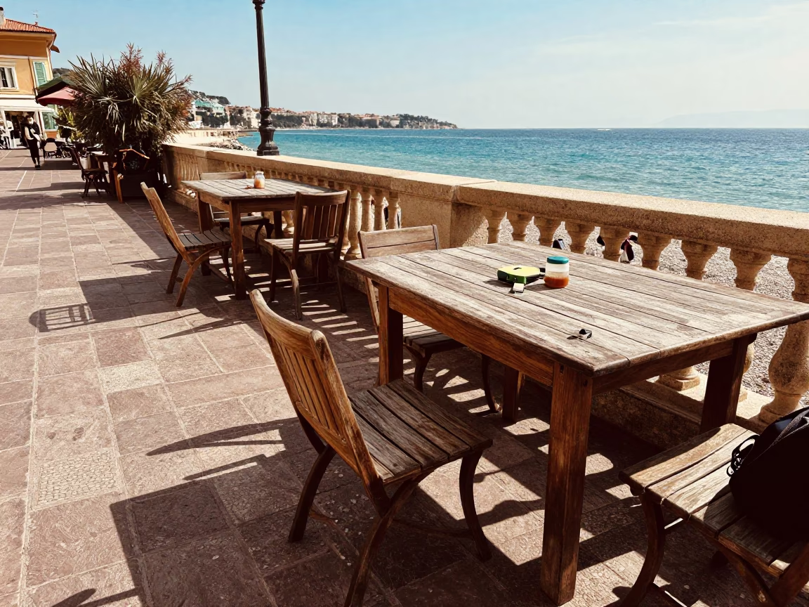 Sunlit Mediterranean Terrace in Nice with Scattered Personal Items and Coastal Views in in Nice, France