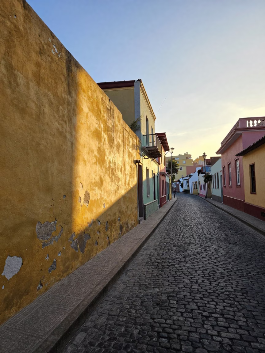 Sunlit Plaster Wall and Cobblestone Street in Valparaiso Chile Morning Light in in Valparaiso, Chile
