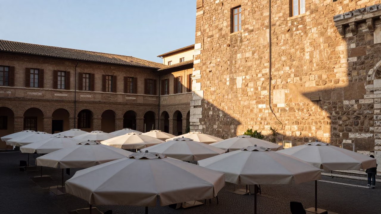 Sunlit Roman Courtyard Umbrellas and Stone Walls Morning Light in in Rome, Italy