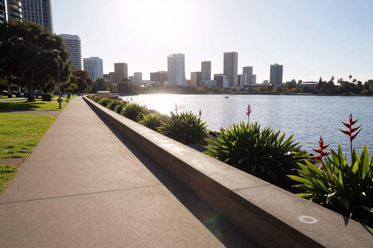 Sunlit Swan River Promenade with Heliconia Blooms and City Skyline in Perth in in Perth, Western Australia, Australia