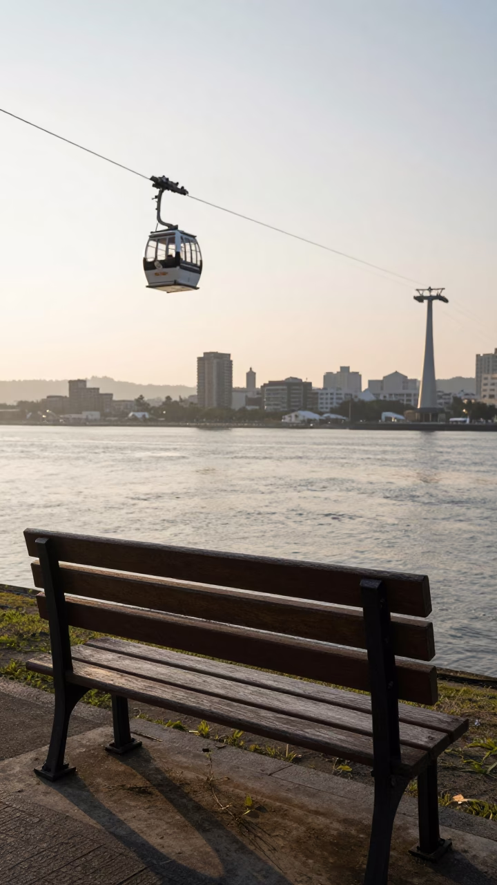 Sunrise Light on Kaohsiung Riverbank Bench with Cable Car View and Morning Tea in in Kaohsiung, Taiwan