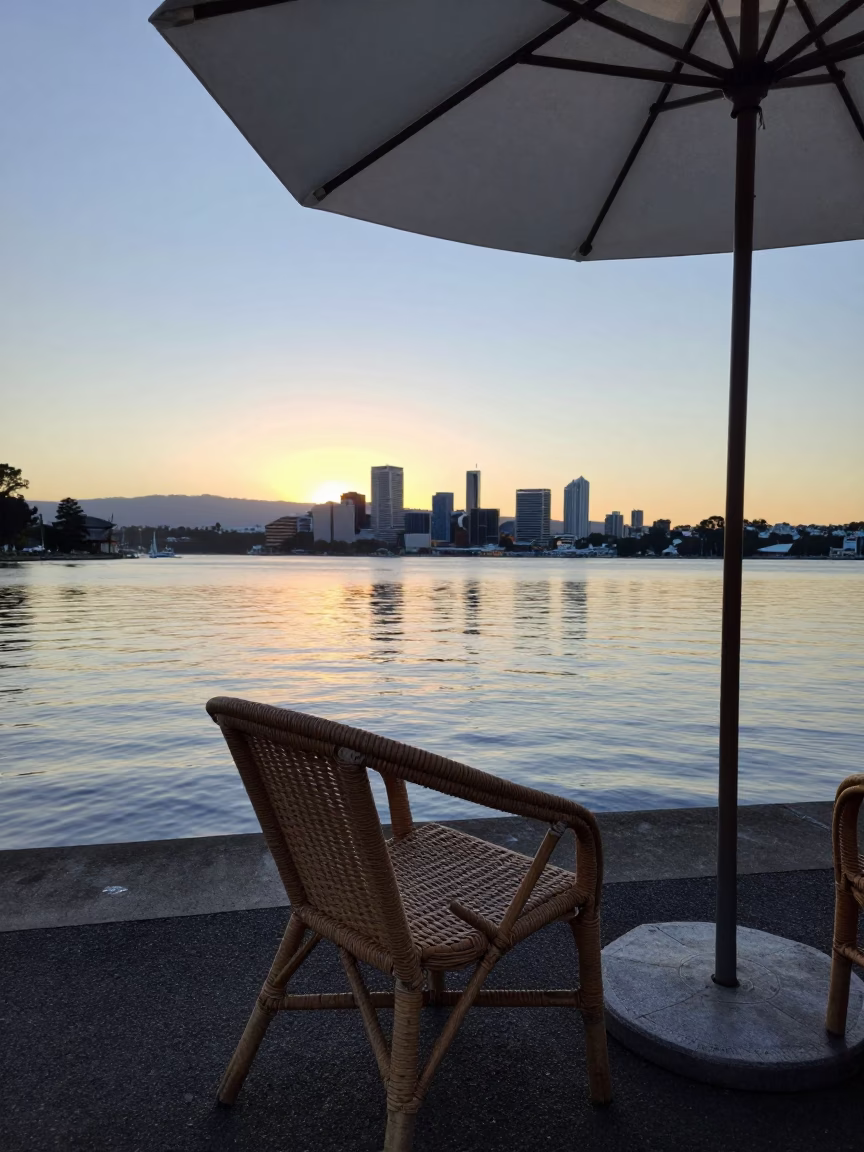 Sunrise over Hobart Waterfront with Rattan Chair and Umbrella Stand in in Hobart, Tasmania, Australia