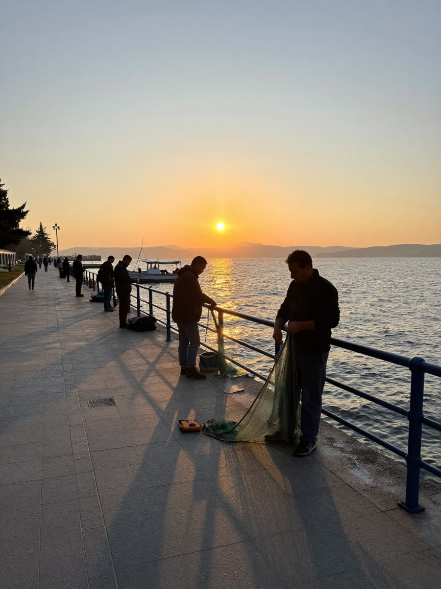 Sunrise over Izmir Kordon waterfront promenade with fishermen and morning light in in Izmir, Turkey