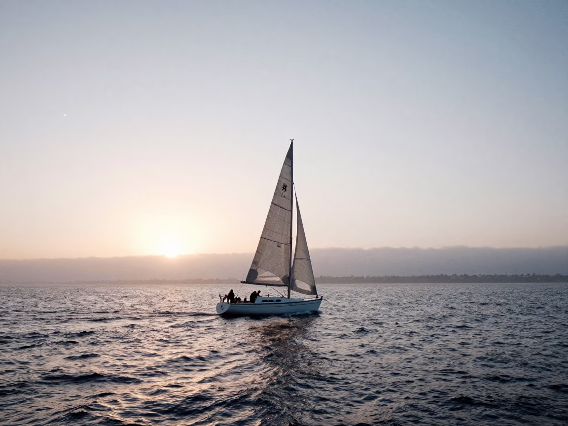 Sunrise over San Diego Bay with Sailboat Tacking in Morning Light in in San Diego, California, United States