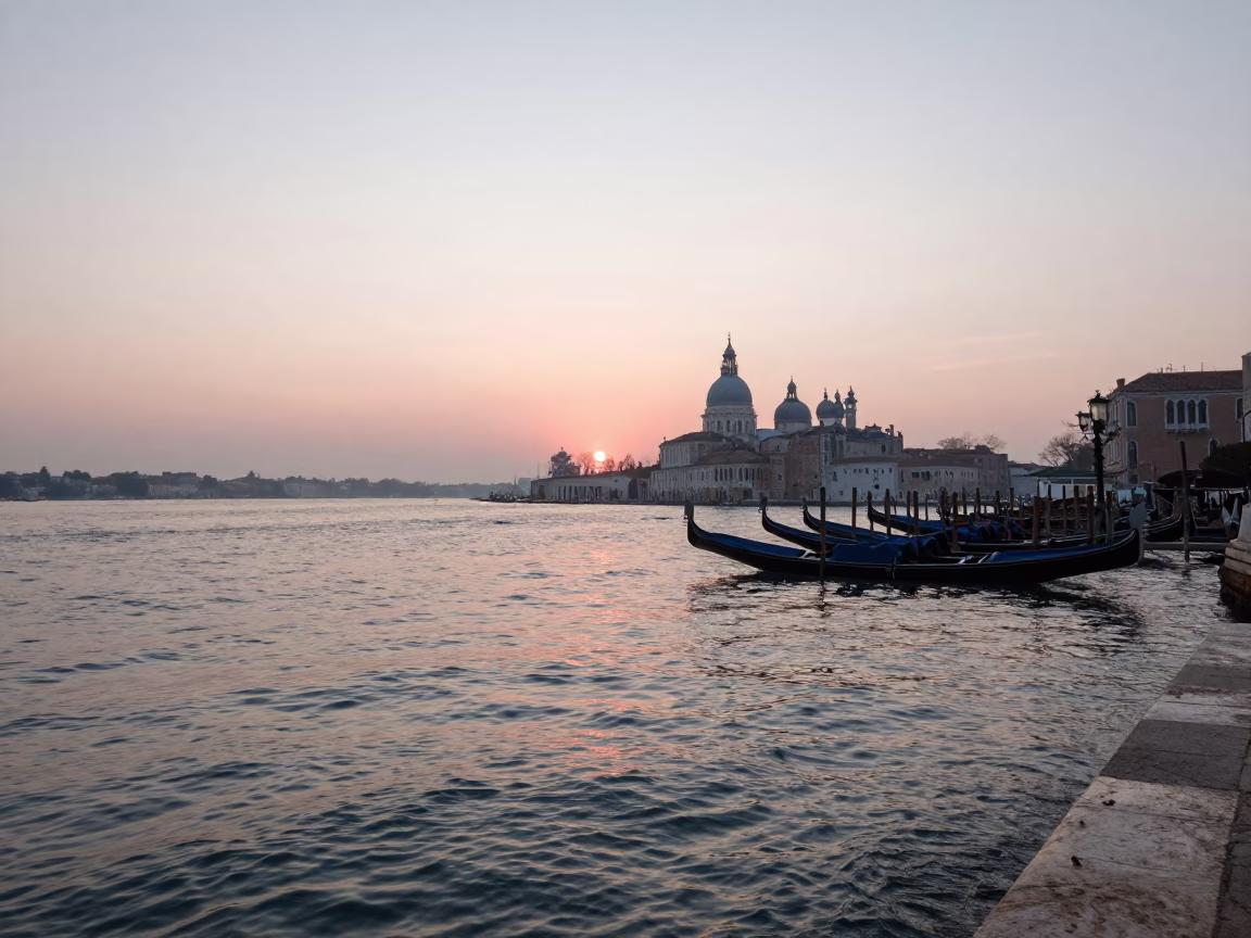 Sunrise over Venetian Lagoon with Gondolas and Historic Architecture in Venice Italy in in Venice, Italy