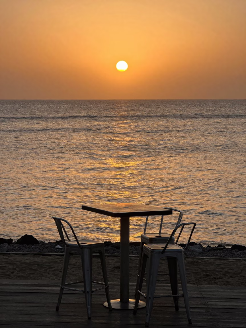 Sunset at Alexandria Corniche with Metal Stools and Beach Deck Chairs in in Alexandria, Egypt