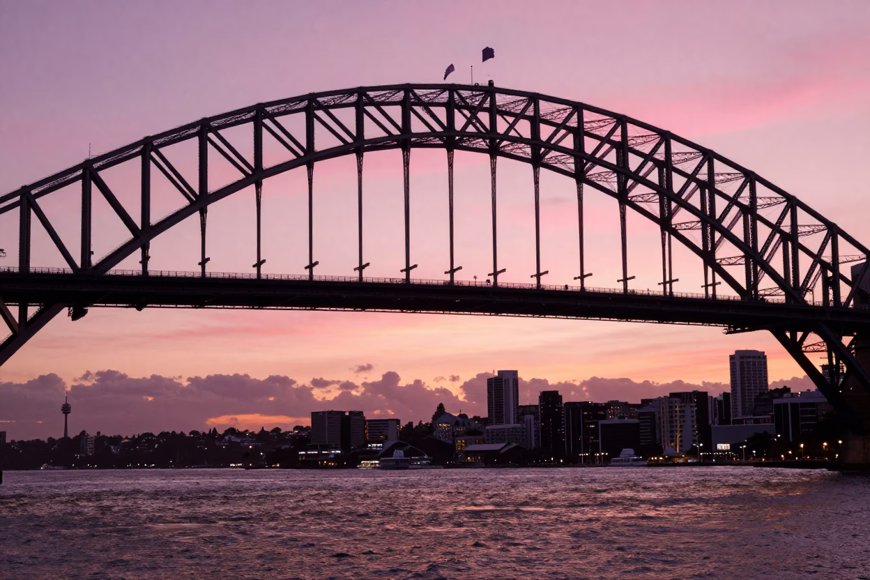 Sunset Glow on Auckland Harbour Bridge Steel Trusses and Harbor Waters in in Auckland, New Zealand