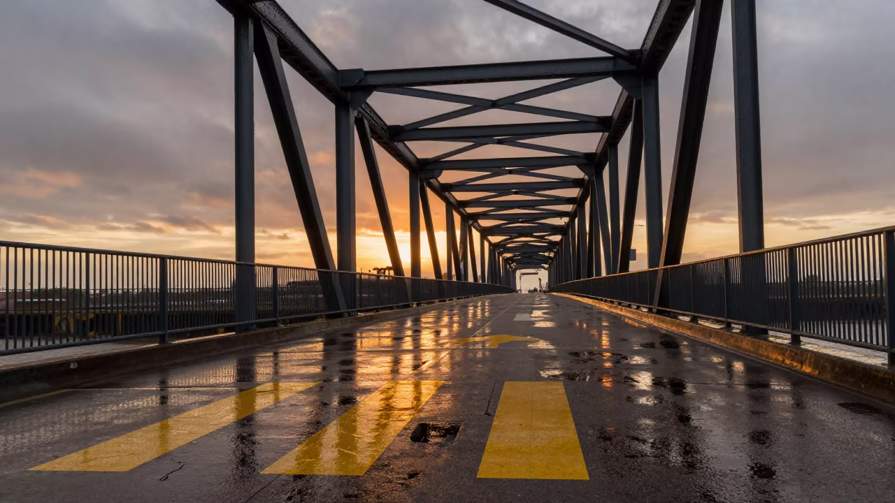 Orange Sunset Light on Drawbridge Deck Markings in under a viaduct of steel and concrete in California
