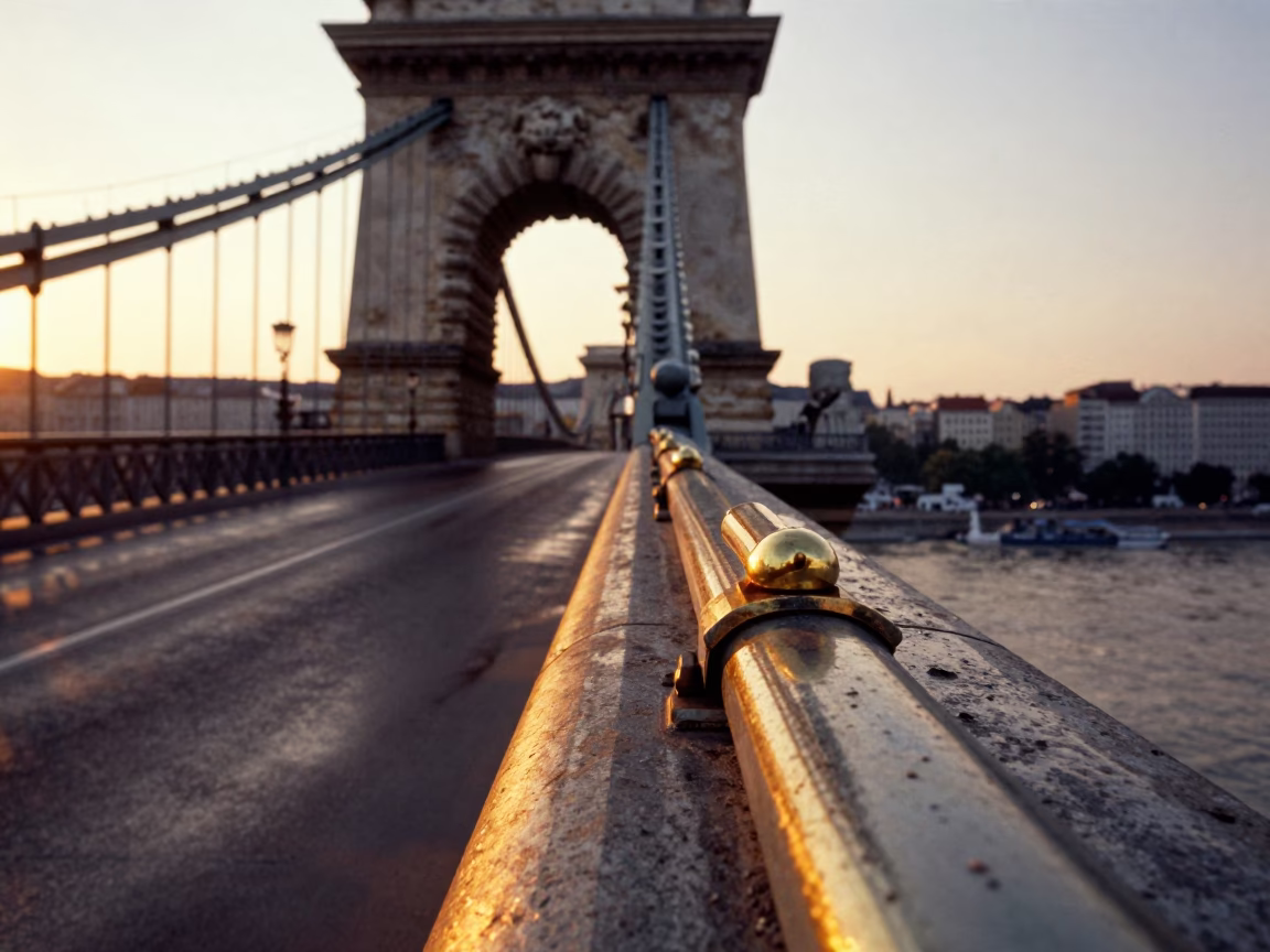 Sunset light on Budapest Chain Bridge pier and brass details in in Budapest, Hungary