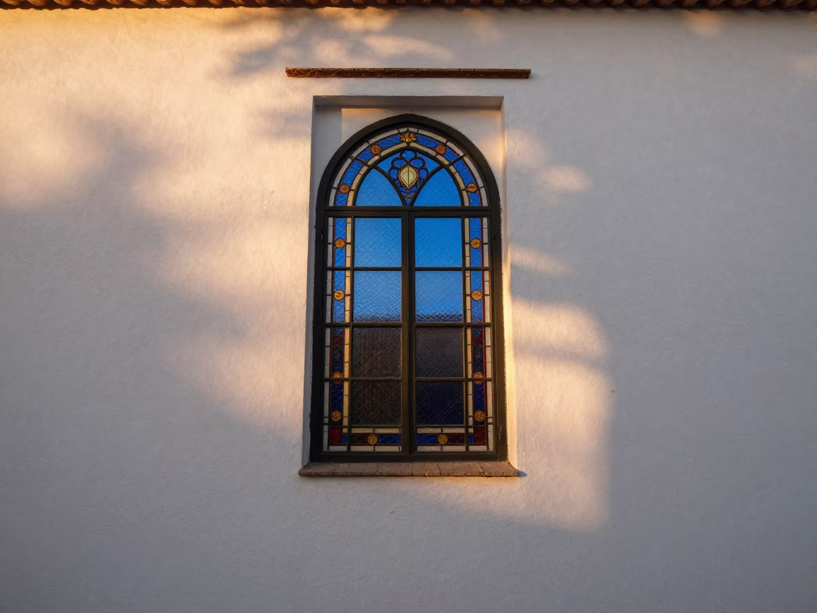 Sunset light through stained glass on white wall in Granada Spain in in Granada, Spain