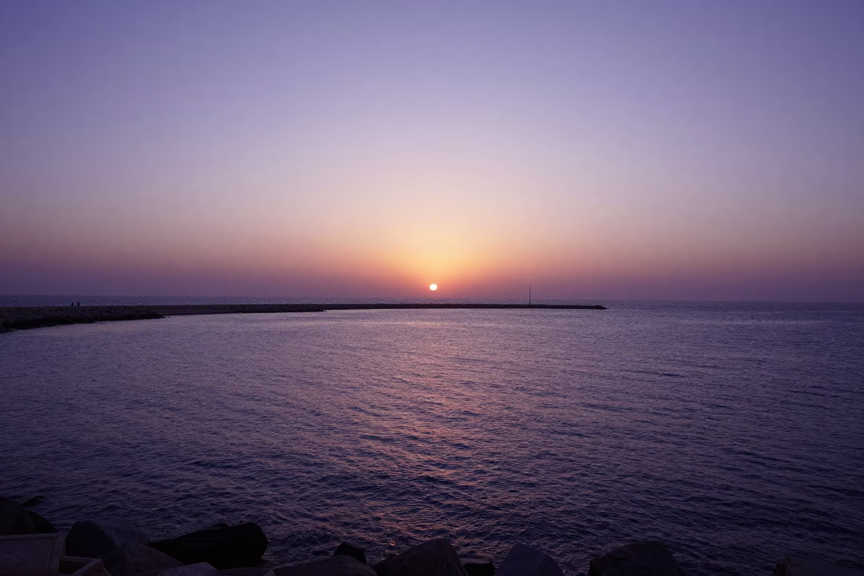 Sunset over Alexandria Egypt Harbor Breakwater and Mediterranean Sea Horizon in in Alexandria, Egypt
