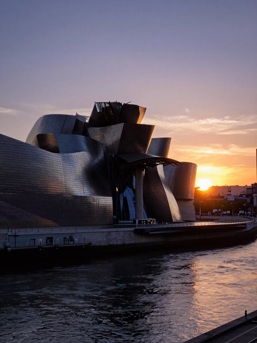 Sunset over Bilbao Guggenheim Museum and Nervion River with Bougainvillea in in Bilbao, Spain