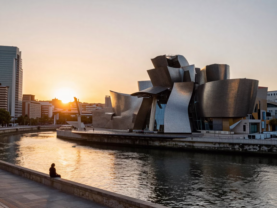 Sunset Over Bilbao's Nervión River with Guggenheim Museum and Local Street Life in in Bilbao, Spain