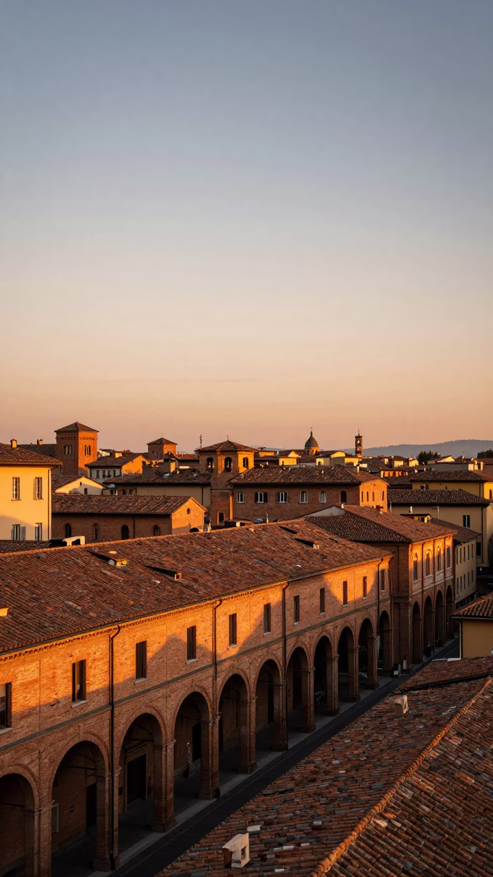 Sunset over Bologna Italy historic porticoes and terracotta rooftops with distant church spires in in Bologna, Italy