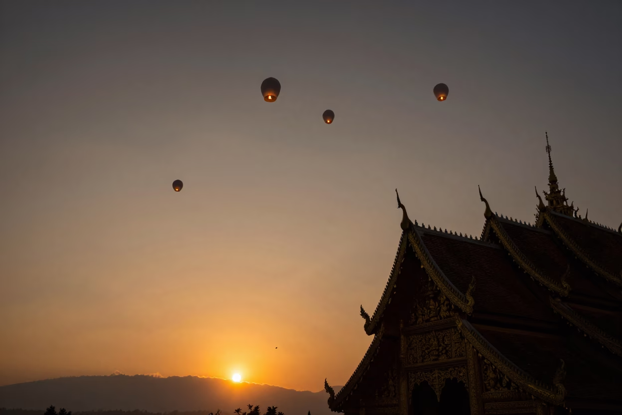 Sunset over Chiang Mai Sky Lanterns Rising Above Ancient Temple Rooftops at Dusk in in Chiang Mai, Thailand