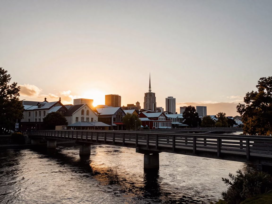 Sunset over Christchurch Avon River with wooden bridge and pedestrians in in Christchurch, New Zealand