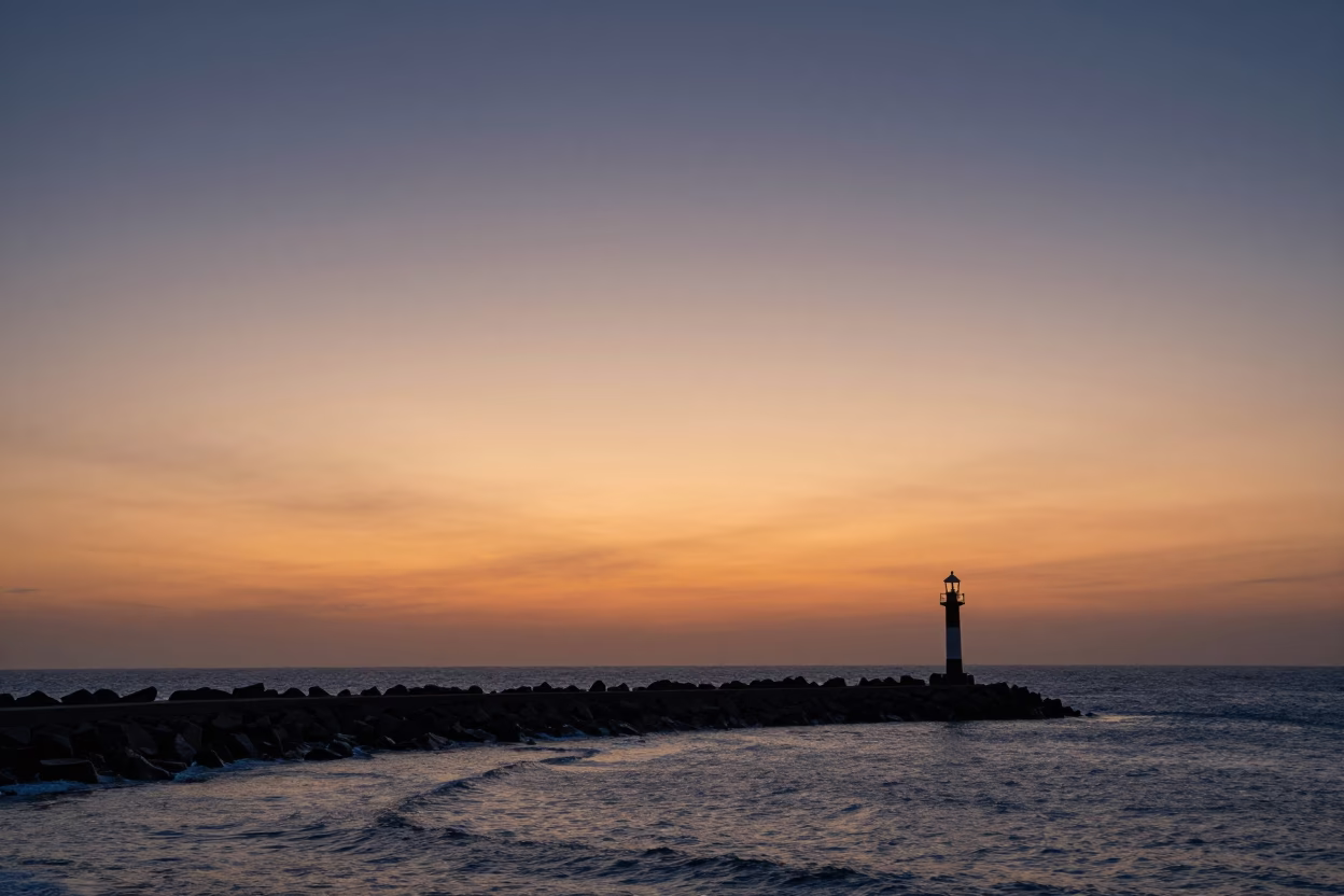 Sunset Over Dakar Senegal Breakwater Curve and Harbor Beacon at Dusk in in Dakar, Senegal