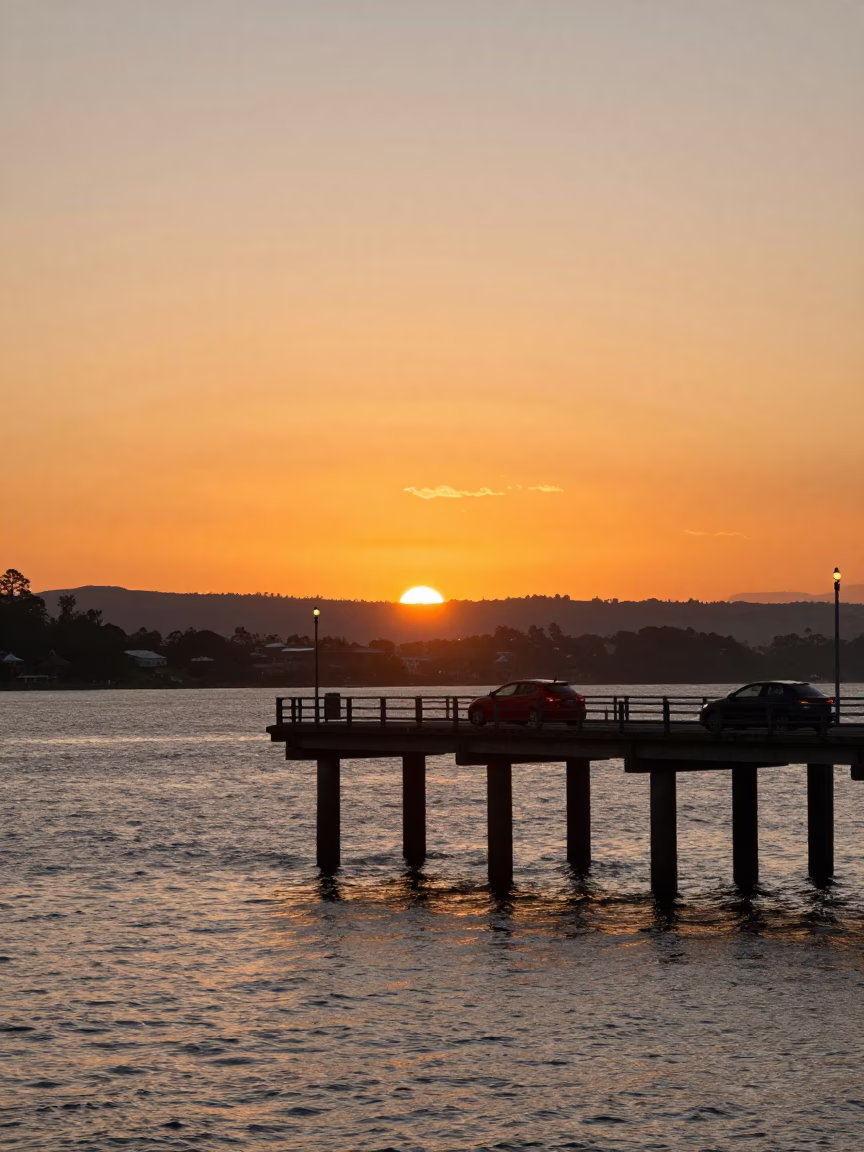 Sunset over Hobart Waterfront with Bridge Piers and Car Headlight Trails in in Hobart, Tasmania, Australia