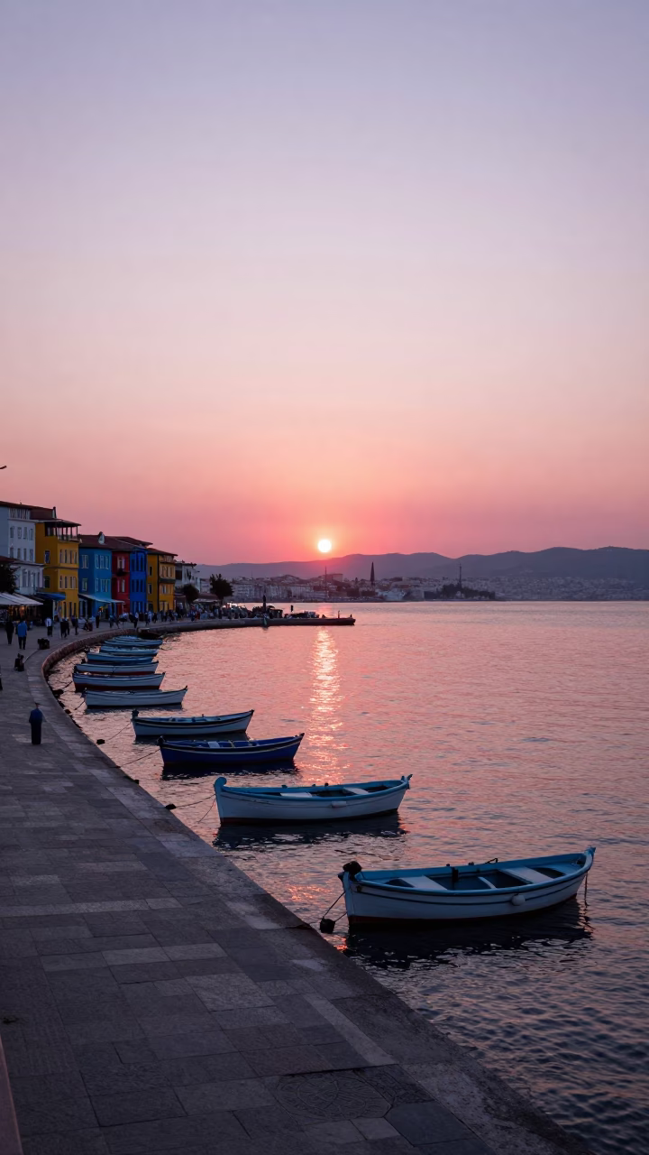 Sunset over Izmir Turkey Harbor with Kordon Promenade and Colorful Boats in in Izmir, Turkey