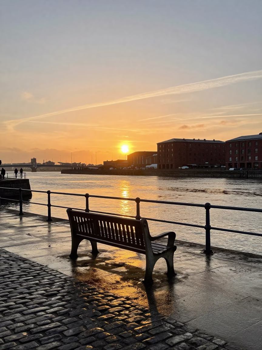 Sunset over Liverpool waterfront with red brick architecture and bustling dockside activity in in Liverpool, United Kingdom