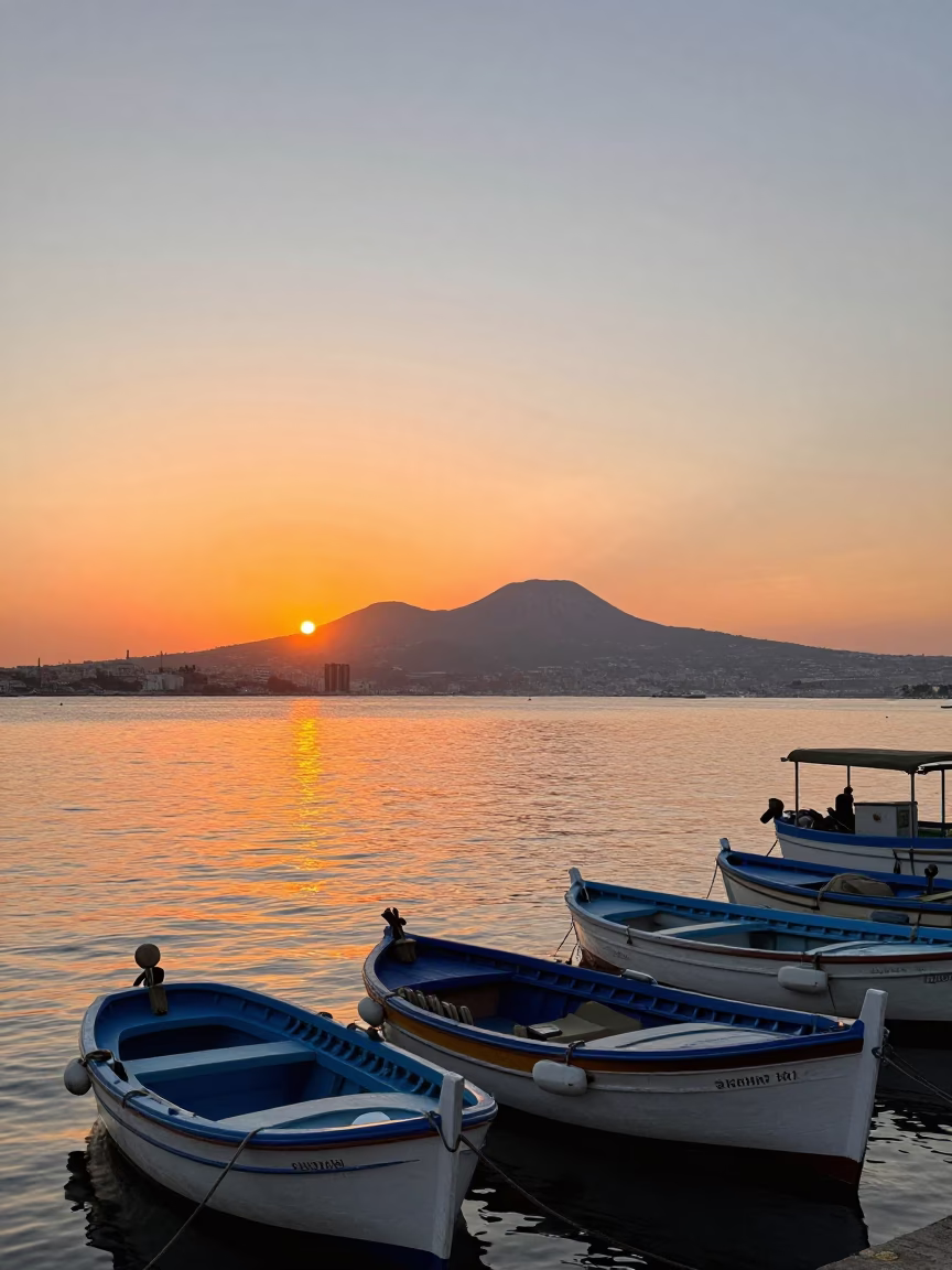 Sunset over Naples Bay with Vesuvio and Colorful Fishing Boats in in Naples, Italy