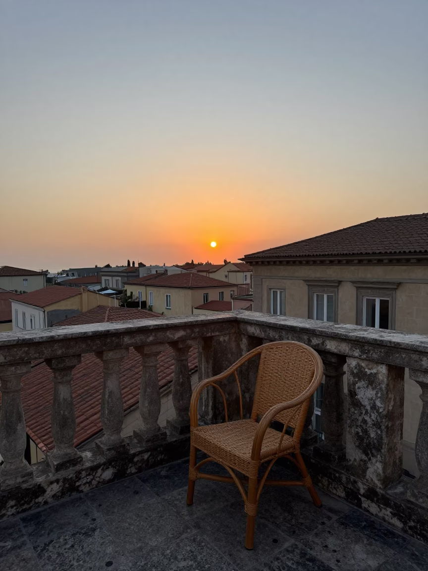 Sunset over Naples Italy with Rattan Chair on Balcony in in Naples, Italy