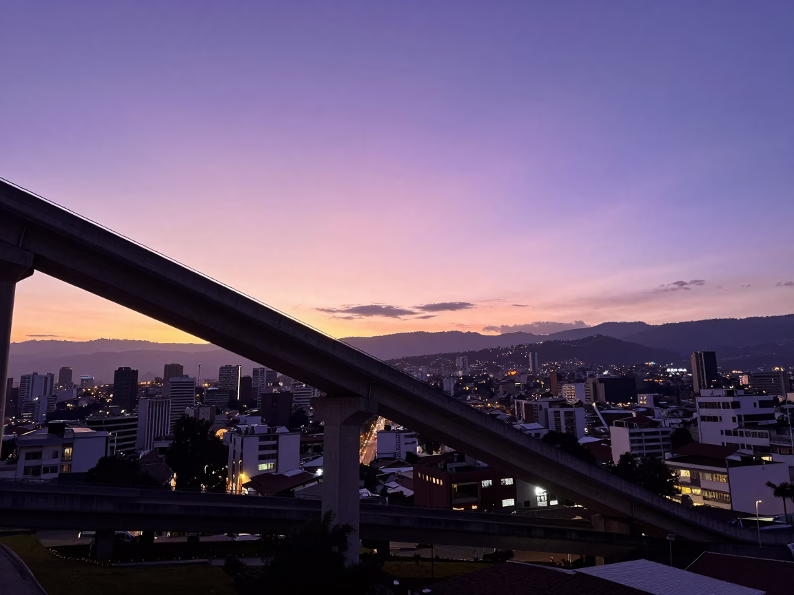 Sunset Over Quito Ecuador Cityscape With Overpass Ramp Slicing Violet Sky in in Quito, Ecuador