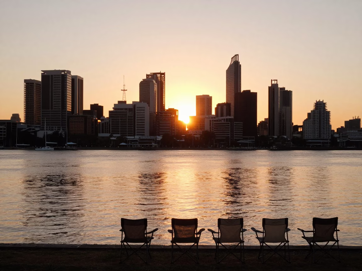 Sunset over Swan River Perth Western Australia with folding chairs and city skyline in in Perth, Western Australia, Australia