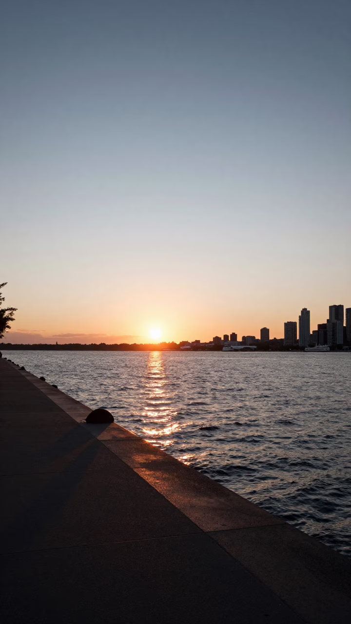 Sunset over Toronto Harbour from the Jack Layton Ferry Terminal with Rusting Bench in in Toronto, Ontario, Canada