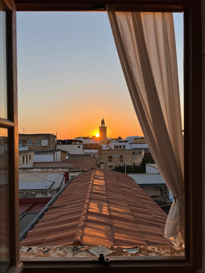 Sunset over Tunis rooftop with laundry and distant minaret in in Tunis, Tunisia