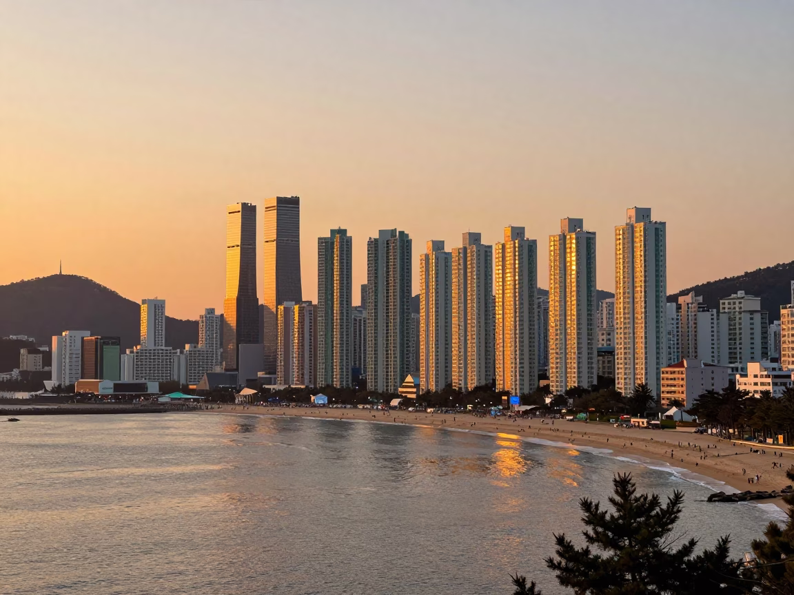 Sunset panorama of Busan skyline and Haeundae beach with distant fishing boats in in Busan, South Korea