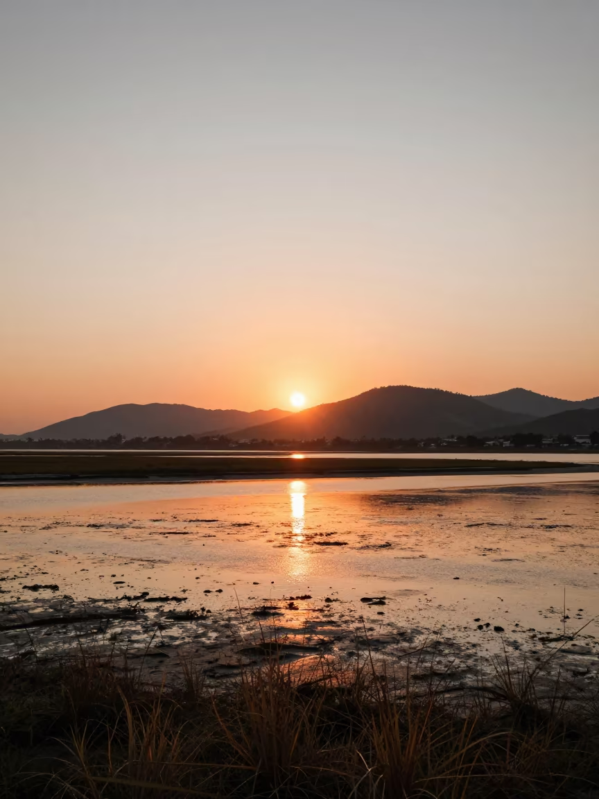 Sunset Reflections on São Paulo Tidal Flats in from a ridge above layered foothills near São Paulo