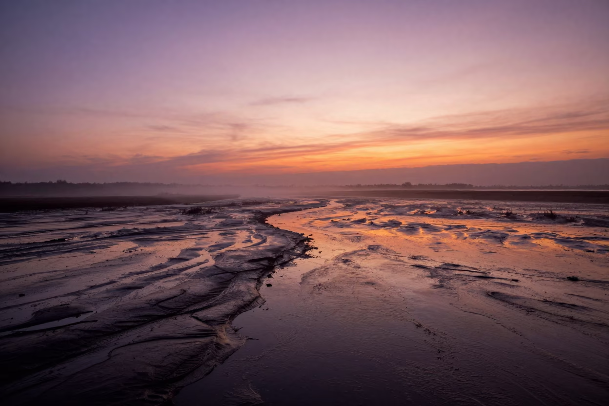 Sunset Reflections on Wet Tidal Flats Ghent in across a wide valley floor near Sint-Pieters, Ghent