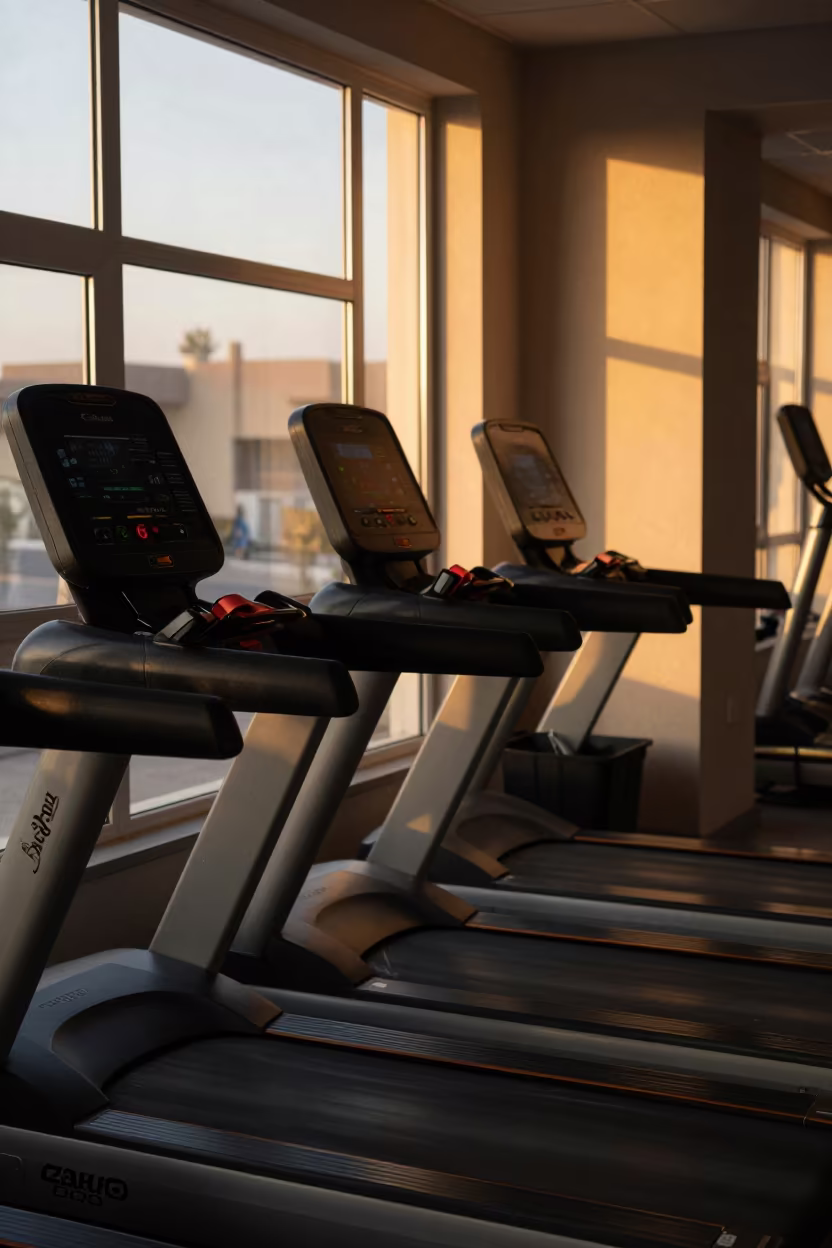 Sunset Reflections on Wiped Treadmill Rails in on an indoor lap-pool deck before open swim in Zakho