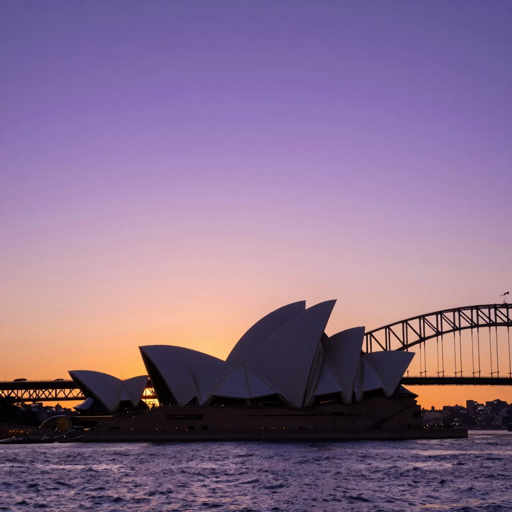 Sunset Silhouette of Sydney Harbour Bridge and Opera House with Ferry Crossing in in Sydney, New South Wales, Australia