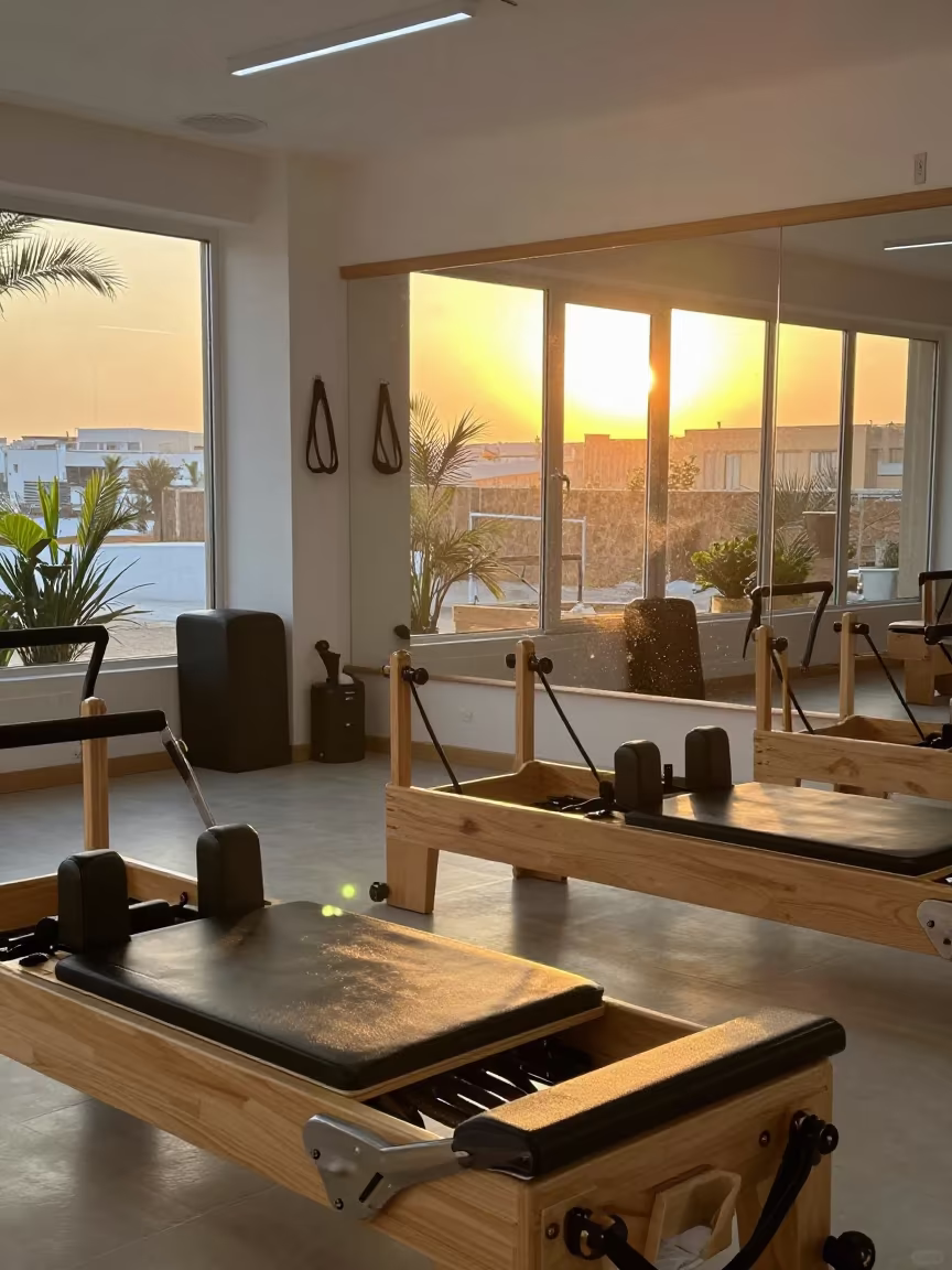 Sunset Spill in Asyut Reformer Studio in inside a spin studio under class lights in Asyut