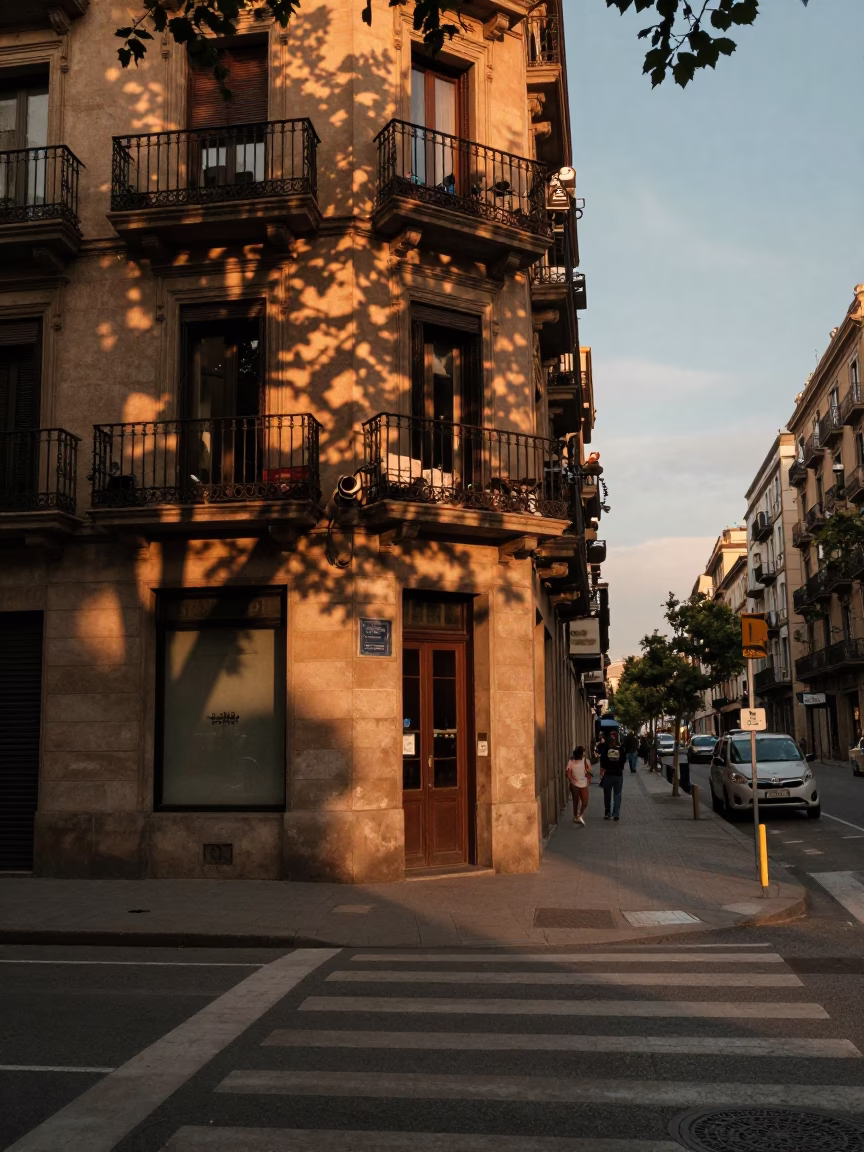 Sunset street scene in Barcelona with leaf shadows and glass handle details in in Barcelona, Spain