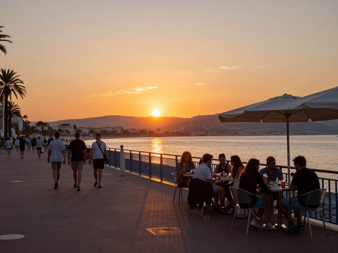 Sunset street scene in Nice France with tourists eating at outdoor cafe tables in in Nice, France