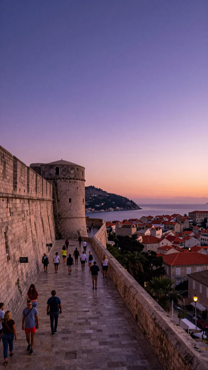 Sunset view of Dubrovnik Old Town stone walls and terracotta roofs from Stradun promenade in in Dubrovnik, Croatia