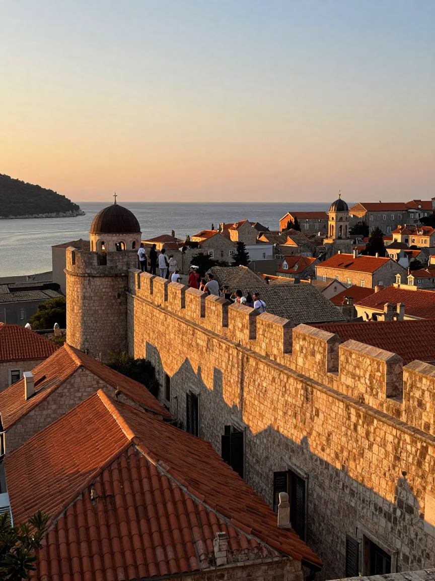 Sunset View of Dubrovnik Old Town Walls with Tourists and Cityscape in in Dubrovnik, Croatia