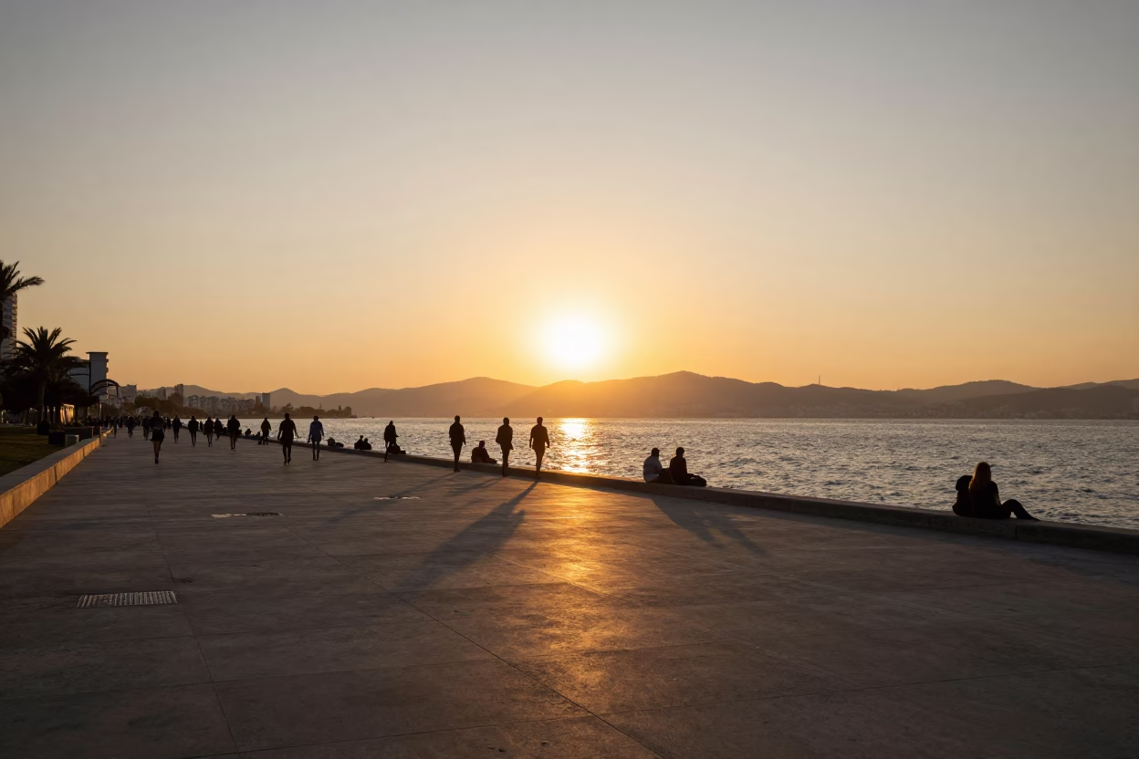 Sunset view of Izmir Bay coastline with Kordon promenade and distant ships in in Izmir, Turkey