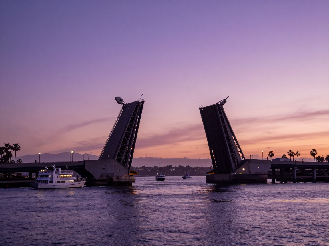 Sunset View of San Diego Bay with Drawbridge Rising Over Tidal Channel in in San Diego, California, United States