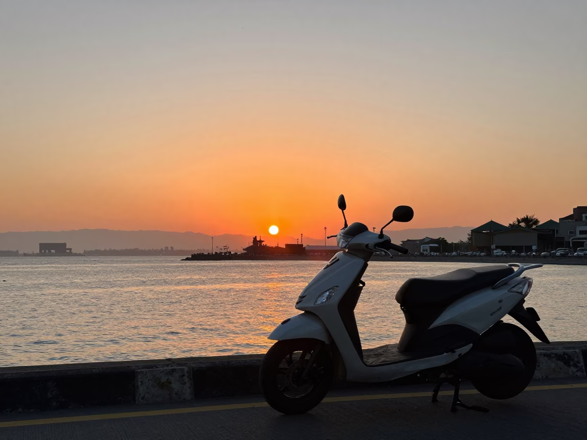 Sunset view of Taipei harbor promenade with parked scooter and city skyline in in Taipei, Taiwan