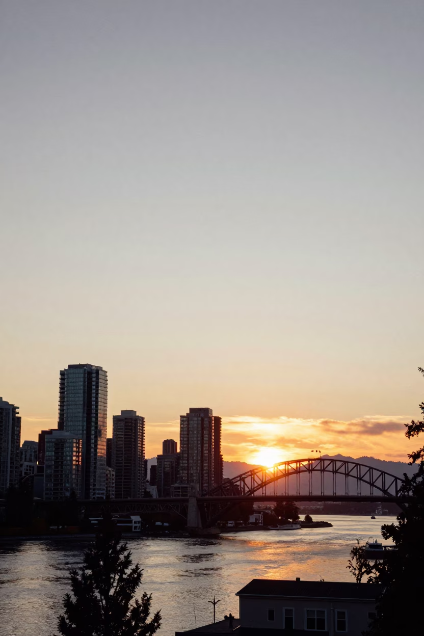 Sunset View of Vancouver Skyline and Harbour Bridge with Coastal Mountain Backdrop in in Vancouver, British Columbia, Canada