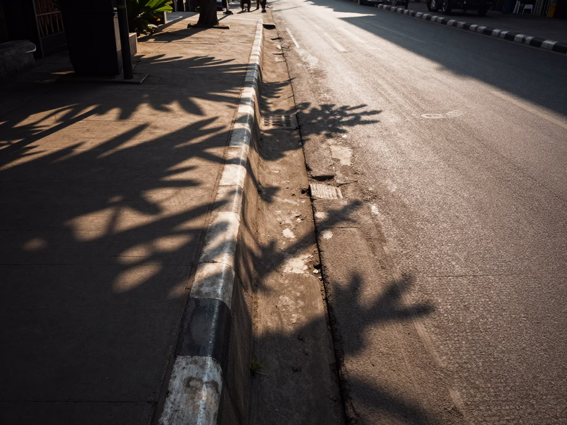 Surabaya Indonesia Late Afternoon Street Scene with Leaf Shadows and Local Market Activity in in Surabaya, Indonesia