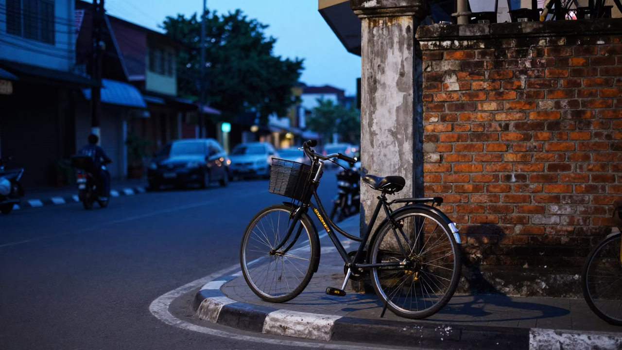 Surabaya Indonesia street corner twilight scene with parked bicycle and ivy on brick wall in in Surabaya, Indonesia