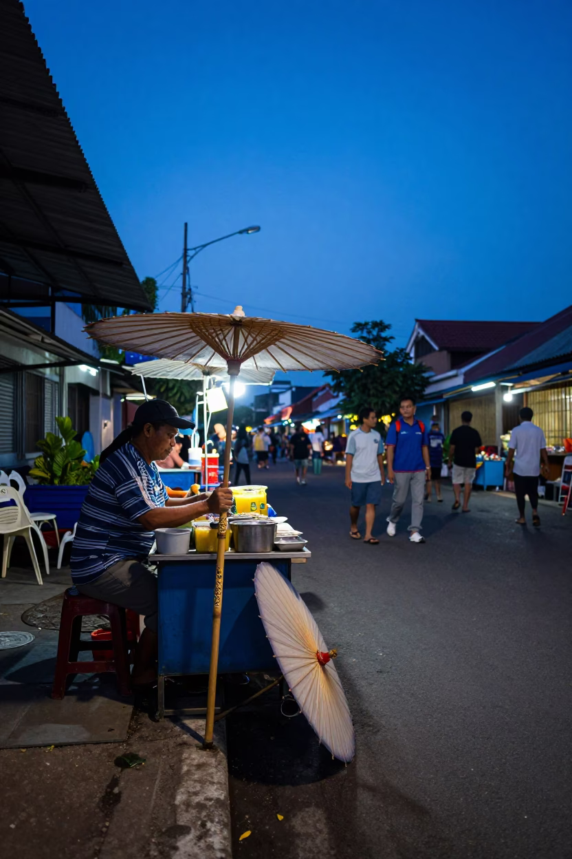 Surabaya Indonesia street scene at blue hour with street food vendor and local traffic in in Surabaya, Indonesia
