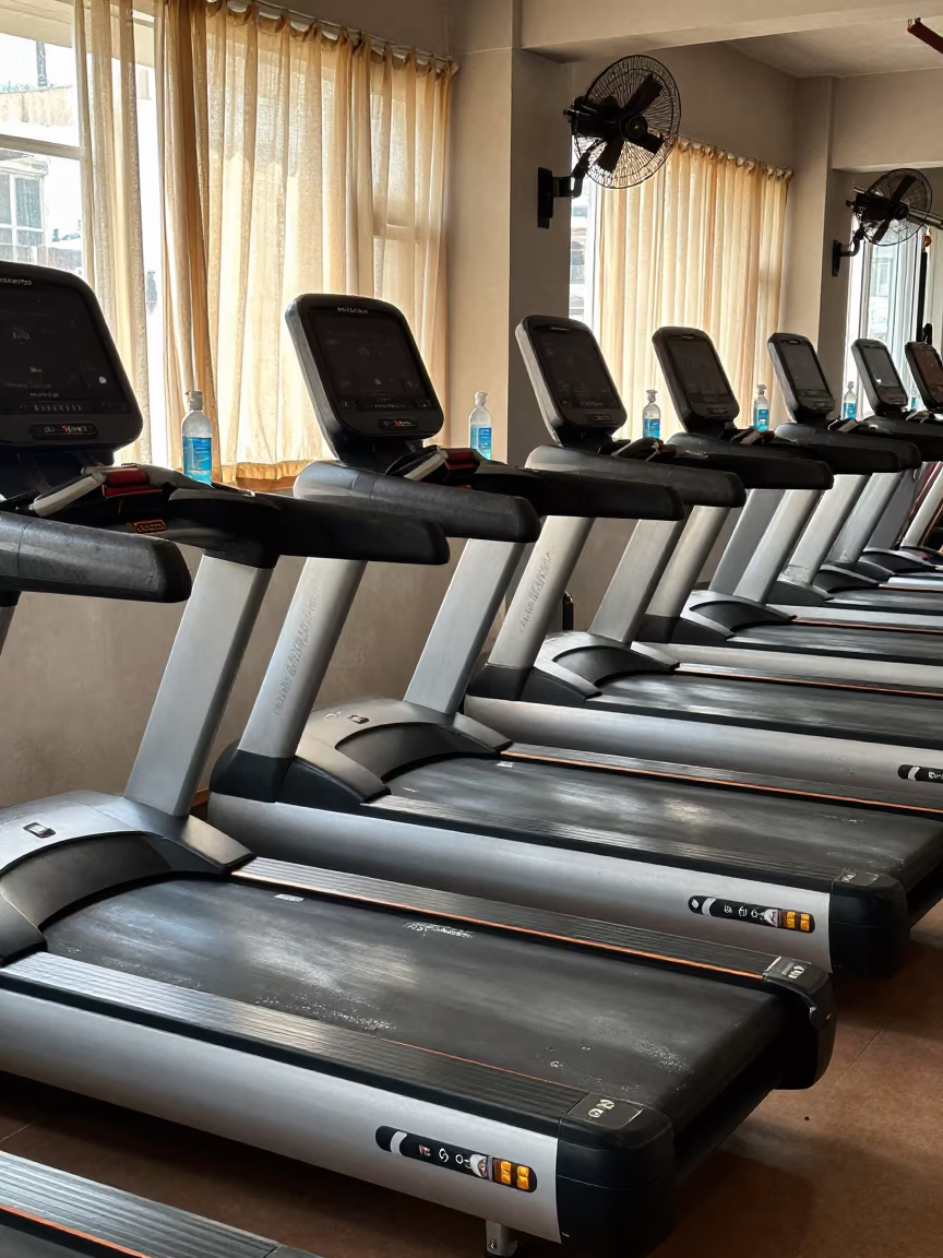 Surat Gym Treadmill Deck After Evening Workout in along a row of machines in a bright gym in Surat